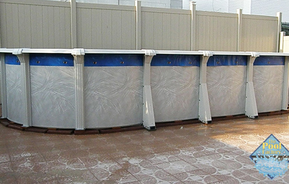 A pool with an overlap liner showing on the outside.